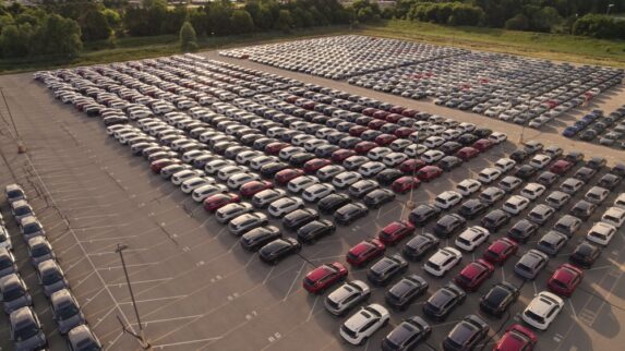 Aerial view of commercial car fleet, representing passive income opportunities through vehicle leasing in self-directed IRAs.
